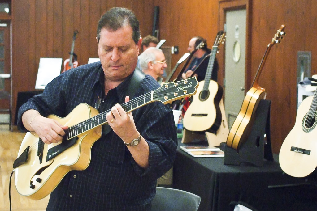 man playing an archtop guitar